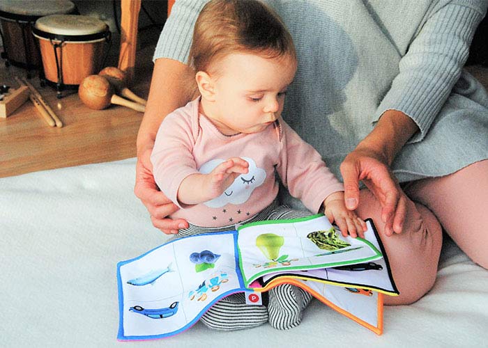 baby reading with mom